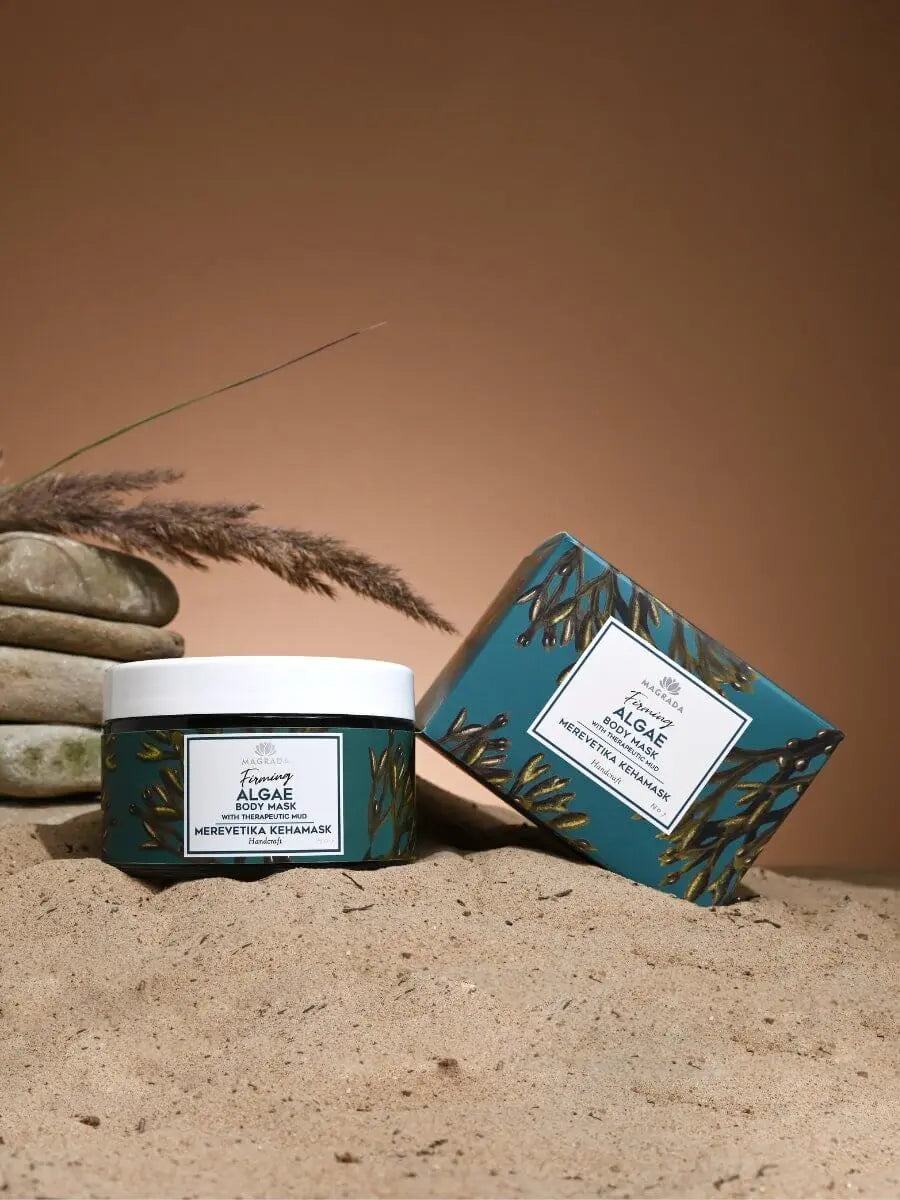 Firming algae body mask and packaging on sandy surface, showcasing organic skincare benefits.